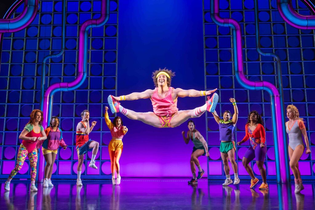 Danny Razzle (Tommy Bracco" doing a toe touch during the "You Crack Me Up" number of "The Heart of Rock and Roll" Broadway musical